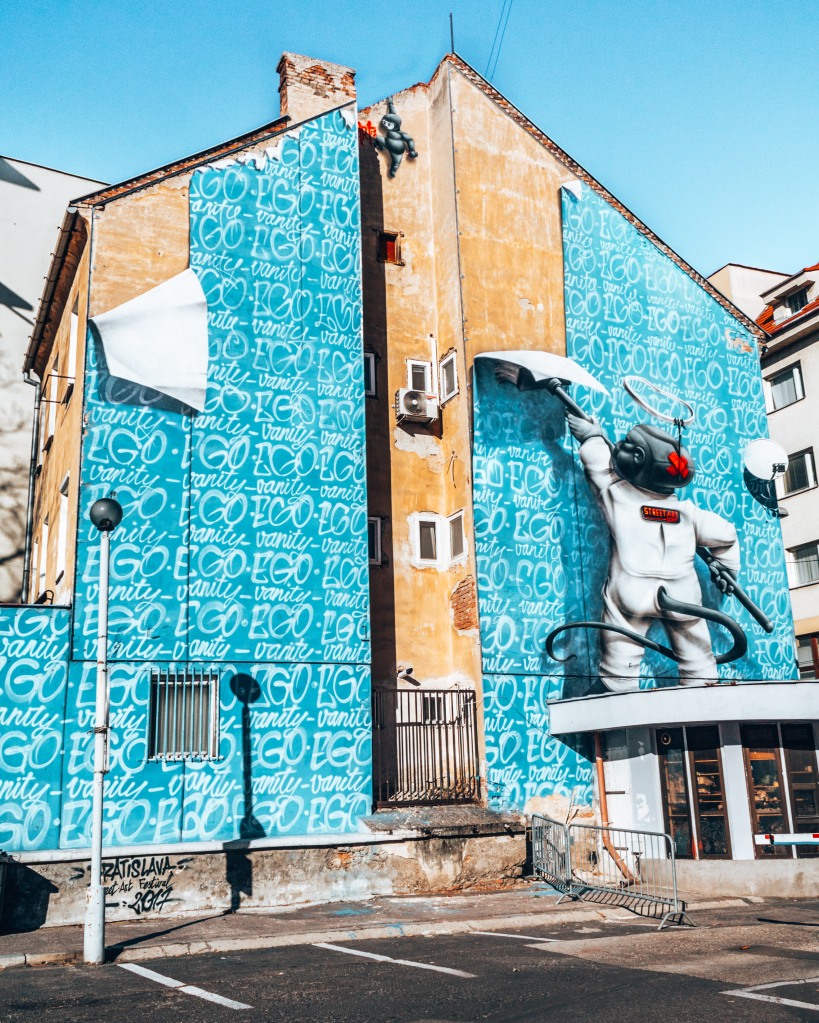 Street art of a baby wallpapering the building in Bratislava, Slovakia