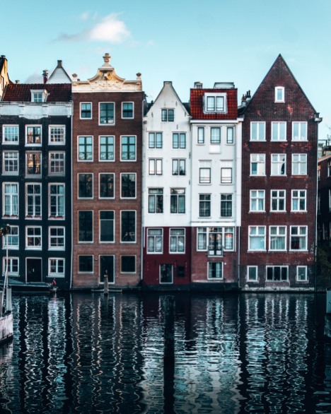 We love the reflections of the houses on the canals of Amsterdam, Netherlands
