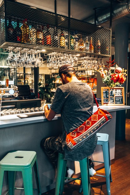 Grab a drink at the bar of the Stayokay Vondelpark hostel in Amsterdam, Netherlands