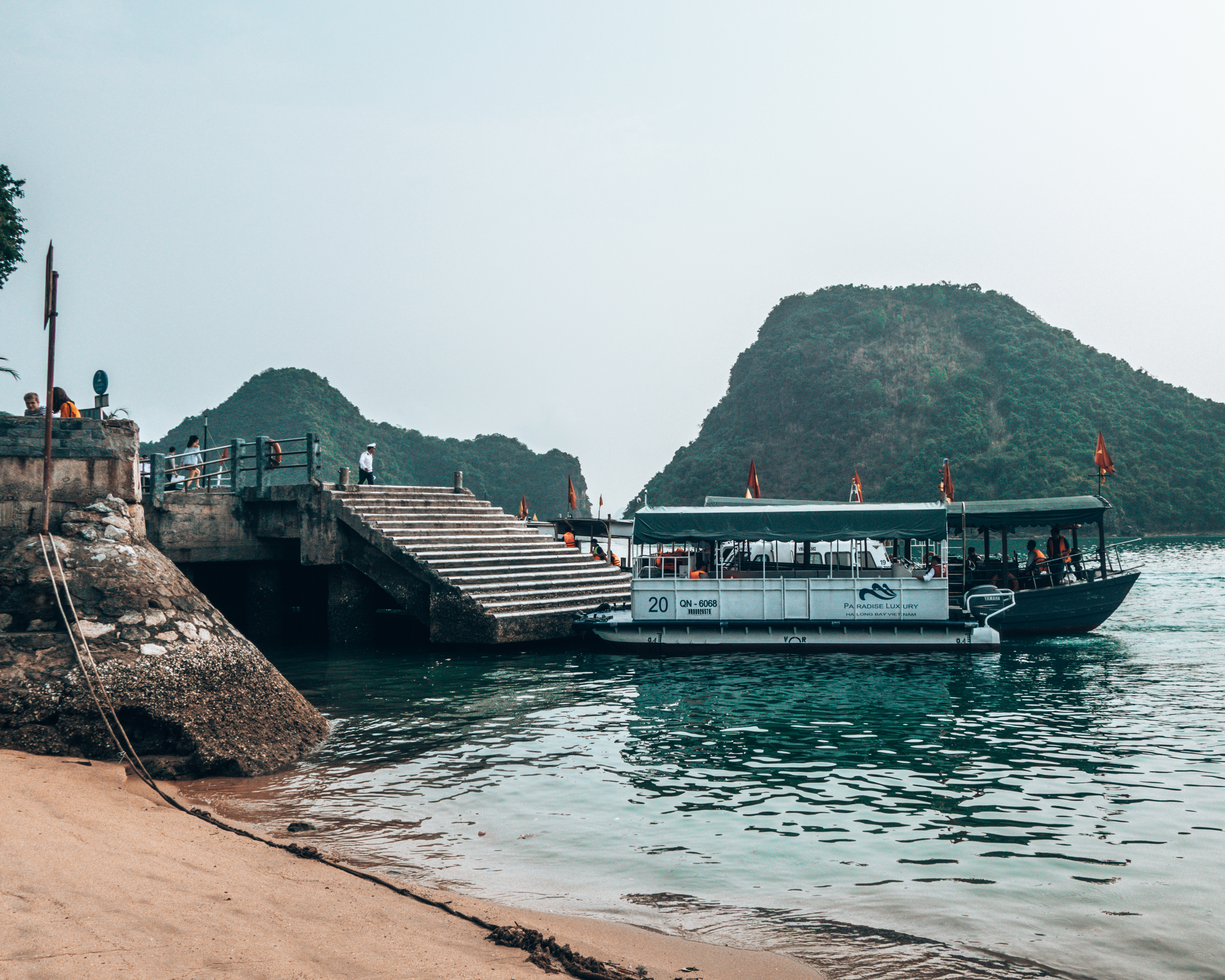 Getting to Ti Top beach by longboat in Halong Bay Vietnam