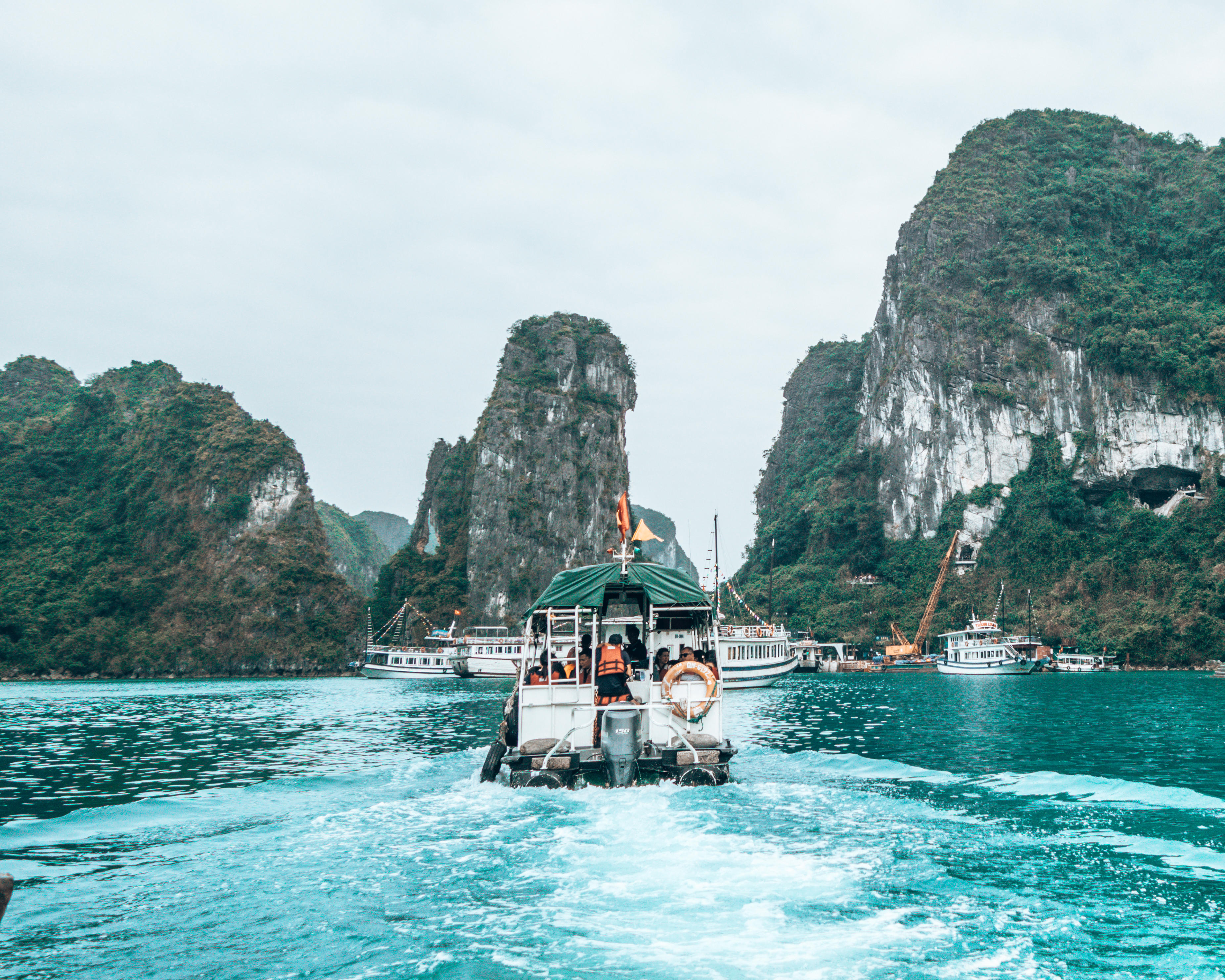 Sailing through Halong Bay Vietnam with many other boats